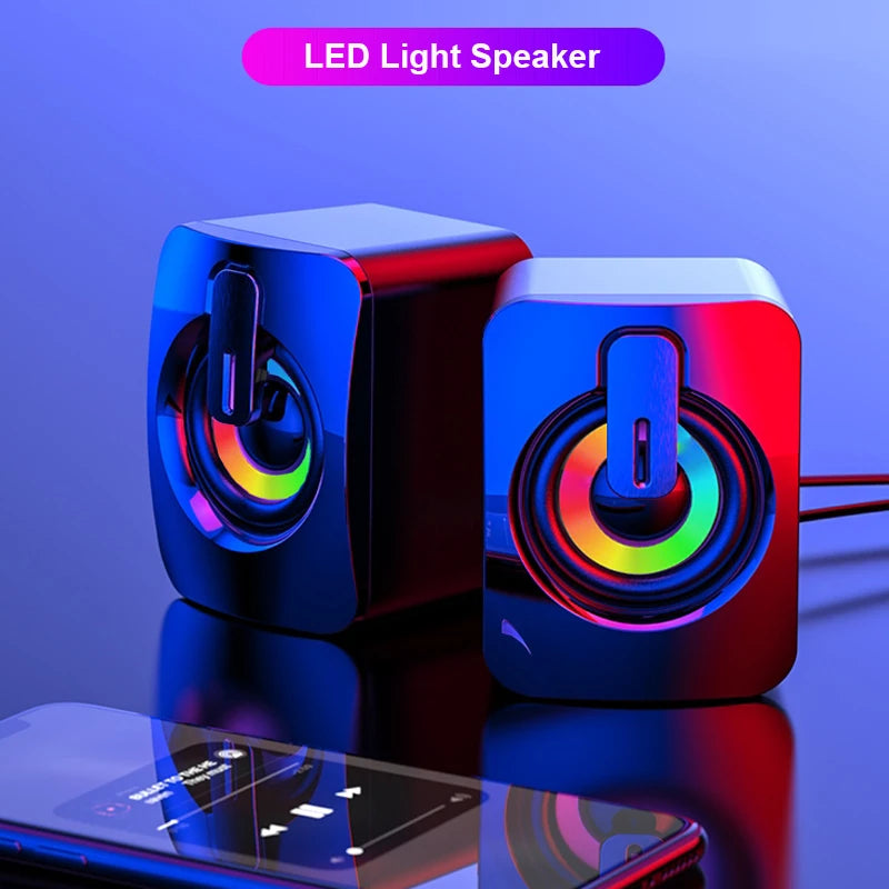 LED light stereo computer speakers connected to smartphone, USB wired PC sound box with vibrant RGB lighting.