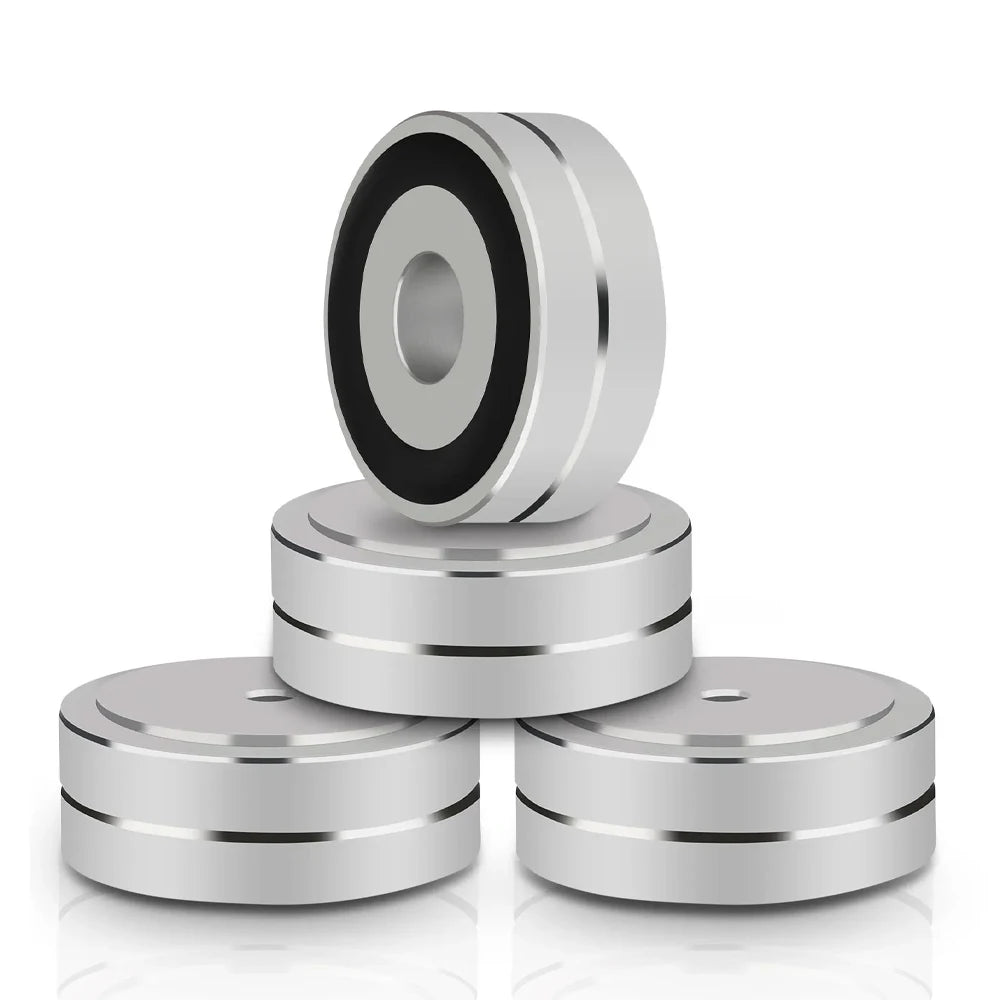 Silver aluminum speaker shoes with non-slip rubber rings, designed to reduce vibration and enhance sound quality in audio equipment setups.