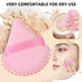 Close-up of pink triangular powder puff from the 25-piece makeup tool set, showing comfortable dry use on face with hand strap.