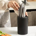 Eco-friendly plastic kitchen knife block stand securely holding stainless steel knives, designed for modern kitchen countertops.