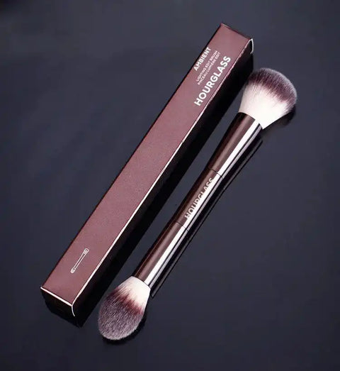 Makeup brush with double-head design and professional metal handle, shown with branded box for blush and loose powder application.