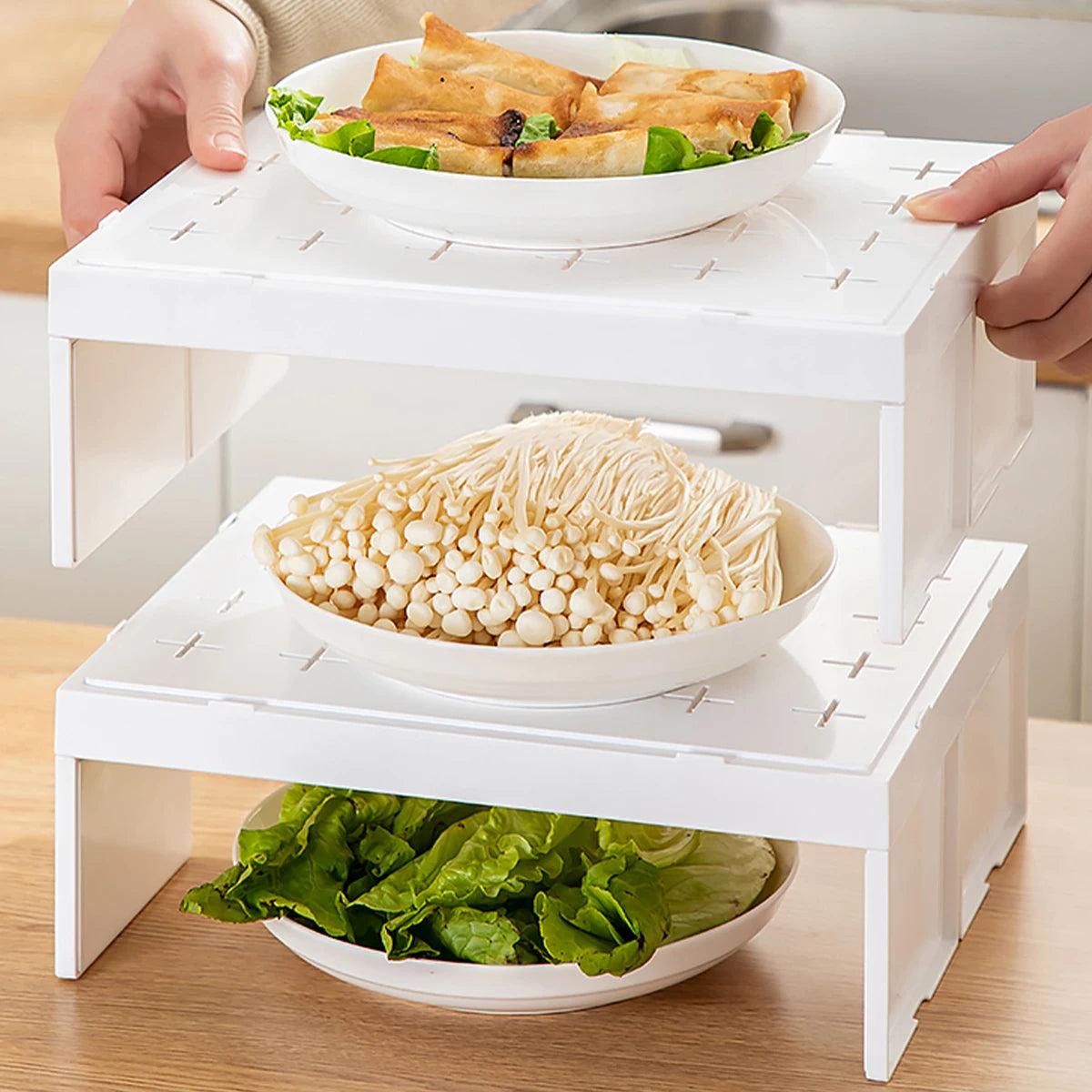 Stackable plastic kitchen storage rack with bowls of vegetables and food