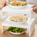 Stackable plastic kitchen storage rack with bowls of vegetables and food