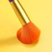 Close-up of orange wool fiber makeup brush from the 15Pcs Colourful Makeup Brush Set, perfect for applying blush or powder foundation.
