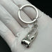 Shiny silver molar tooth keychain charm, a unique dentist gift or dental hygiene accessory for boys, girls, or dental professionals.