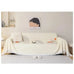 Cream sofa towel cover with abstract patterns and tassel edge, non-slip and breathable, enhancing a minimalist living room setup.