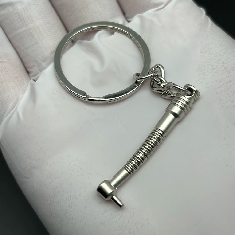 Silver dentist drill charm keychain from DENTOSEE, ideal dental hygiene graduation gift or dentist accessory for kids and adults.