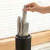 Modern black kitchen tools stand for chef's knife with vertical knife slots, ideal for organized knife storage in home kitchens.